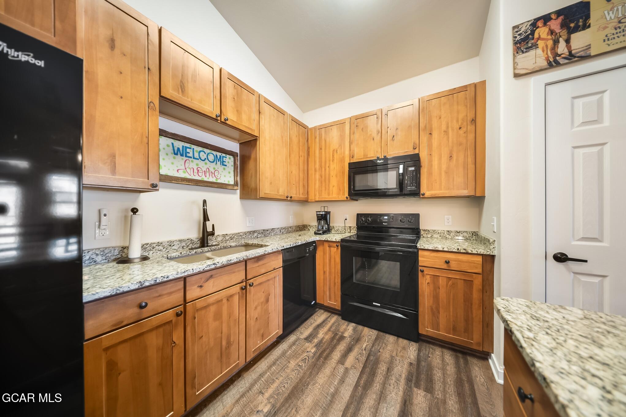 162 Village Road, Unit G303 Granby, CO 80446 - Photo 5 of 37 a kitchen with stainless steel appliances granite countertop a stove a sink and a microwave