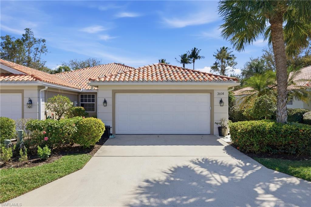 3614 El Segundo Court Naples, FL 34109 - Photo 1 of 49 a front view of a house with a garden and palm tree
