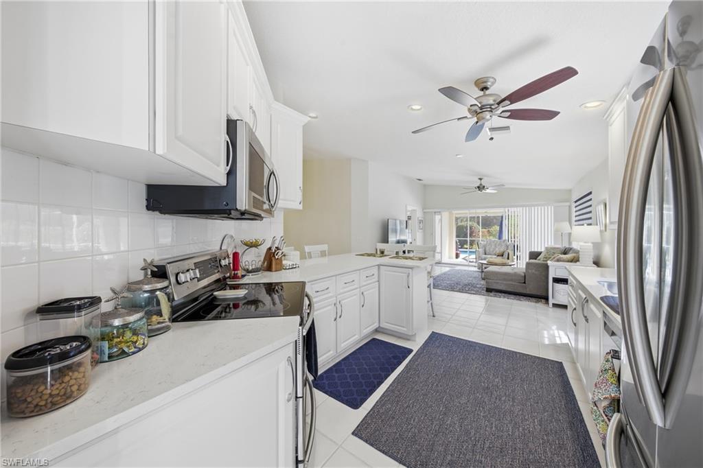 3614 El Segundo Court Naples, FL 34109 - Photo 13 of 49 a kitchen with a sink appliances cabinets and a counter top space