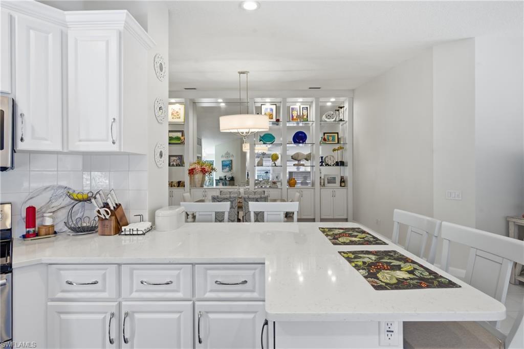 3614 El Segundo Court Naples, FL 34109 - Photo 15 of 49 a kitchen with white cabinets and appliances
