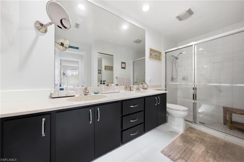 3614 El Segundo Court Naples, FL 34109 - Photo 19 of 49 a bathroom with a double vanity sink and a toilet
