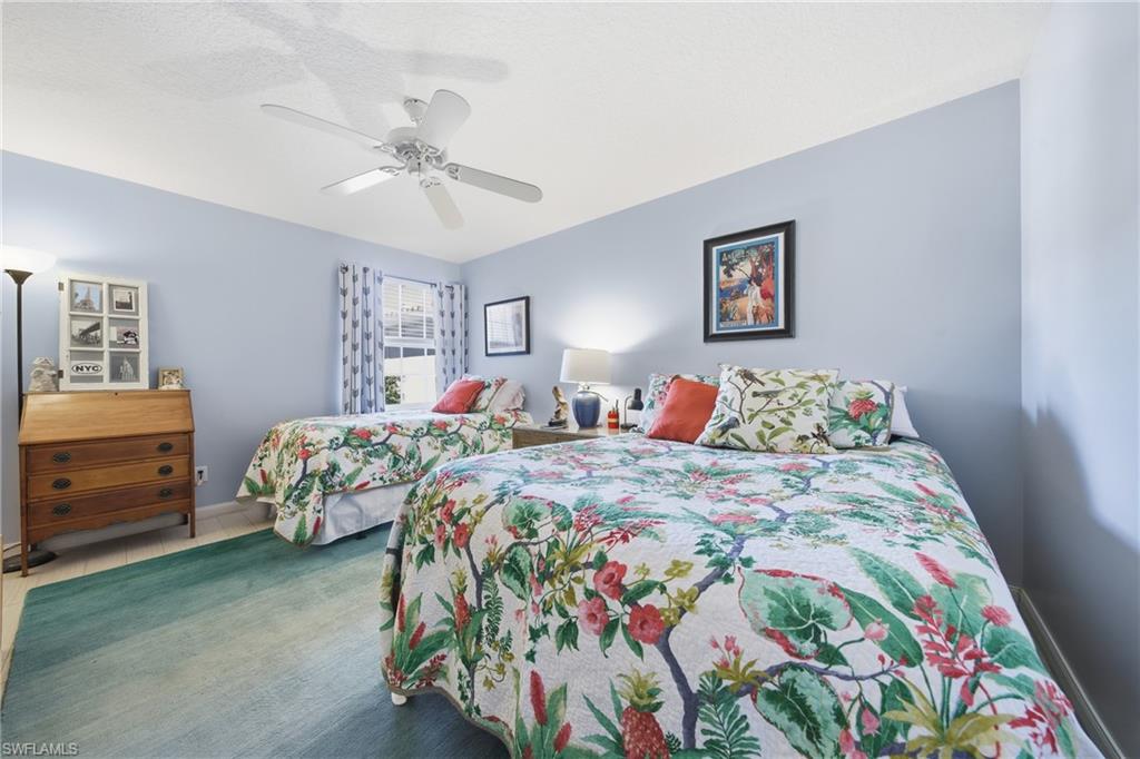 3614 El Segundo Court Naples, FL 34109 - Photo 21 of 49 a bedroom with two beds and a dresser