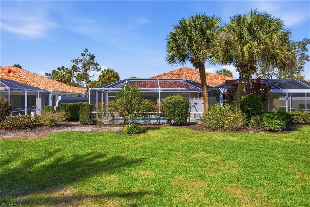 3614 El Segundo Court Naples, FL 34109 - Photo 27 of 49 a front view of a house with patio and garden
