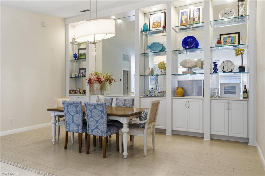 3614 El Segundo Court Naples, FL 34109 - Photo 9 of 49 a view of a dining room with a table and chairs