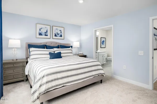 a bedroom with a bed and painting on the wall