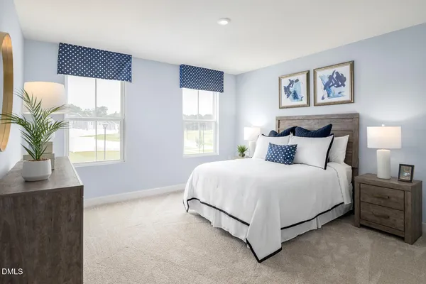 a bedroom with a bed a mirror and a window