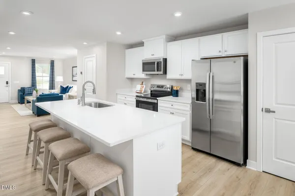 a kitchen with stainless steel appliances a refrigerator stove microwave and cabinets