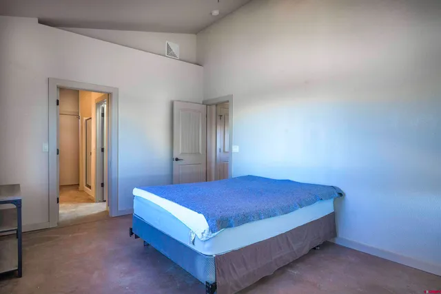 a bedroom with a bed and a table