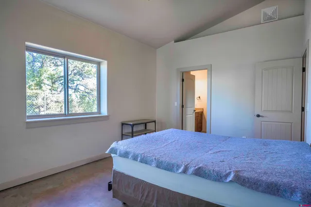 a bedroom with a bed and window