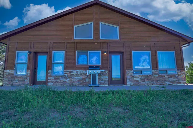 a view of house with a yard