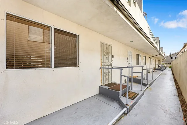 a view of a hallway with wooden floor and fence