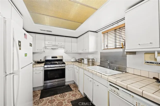 a kitchen with a sink cabinets and window