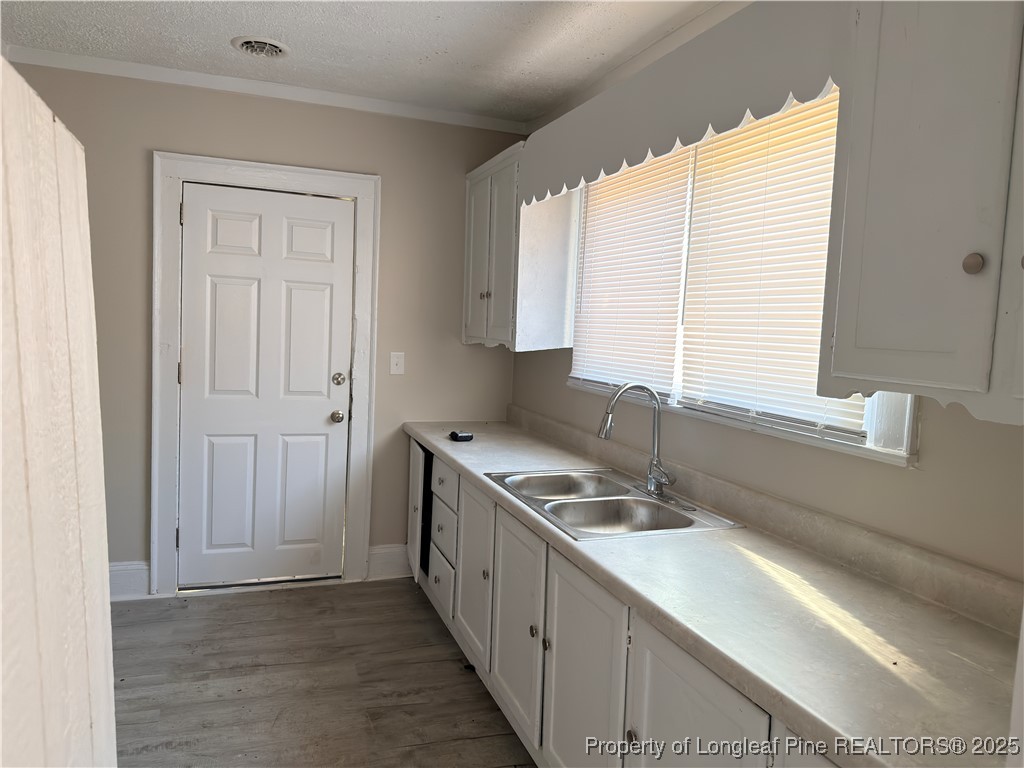 307 Hawthorne Road Fayetteville, NC 28301 - Photo 4 of 11 a kitchen with stainless steel appliances granite countertop a sink and a stove