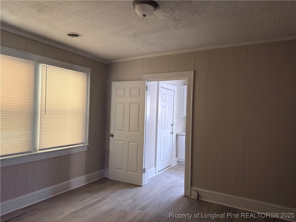 307 Hawthorne Road Fayetteville, NC 28301 - Photo 6 of 11 a view of an empty room with wooden floor and a window