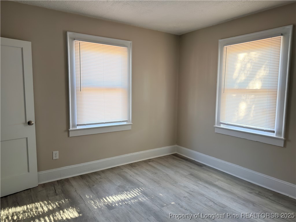 307 Hawthorne Road Fayetteville, NC 28301 - Photo 8 of 11 a view of an empty room with wooden floor and a window