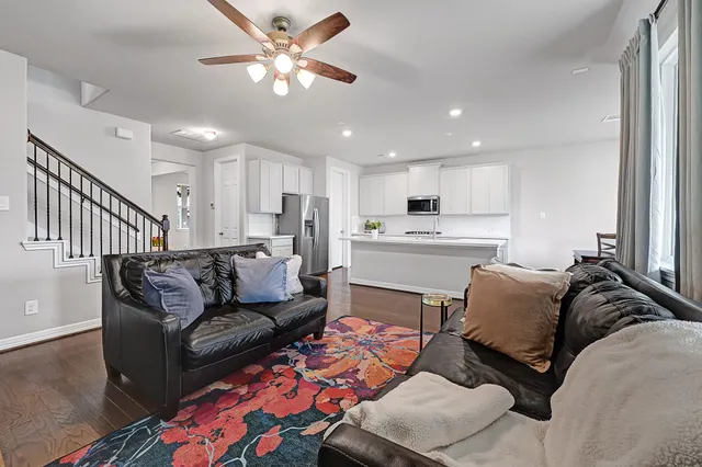 a living room with furniture and kitchen view