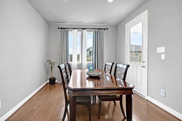 a view of a dining room with furniture window and wooden floor