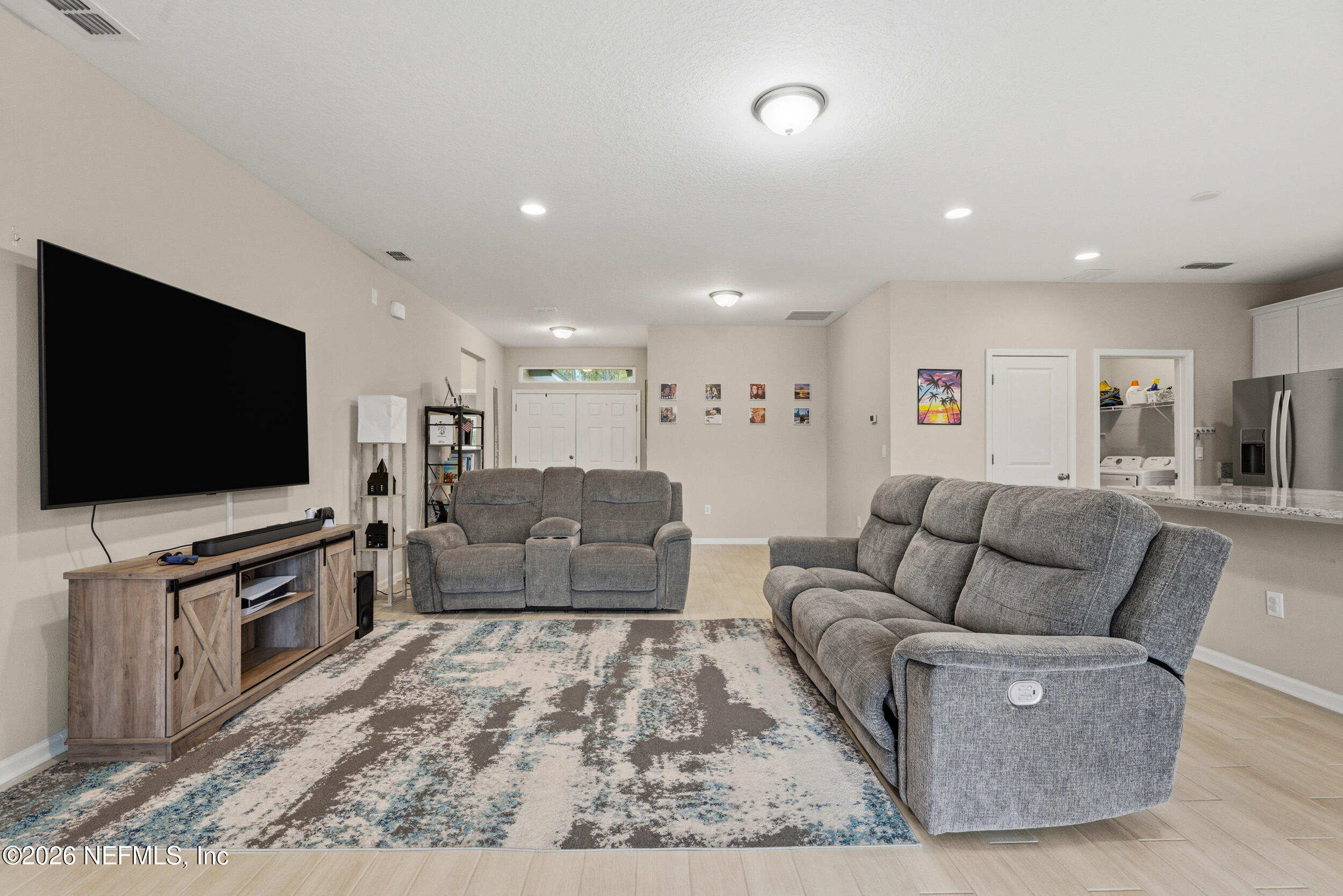 635 Sycamore Way Orange Park, FL 32073 - Photo 14 of 42 a living room with furniture and a flat screen tv