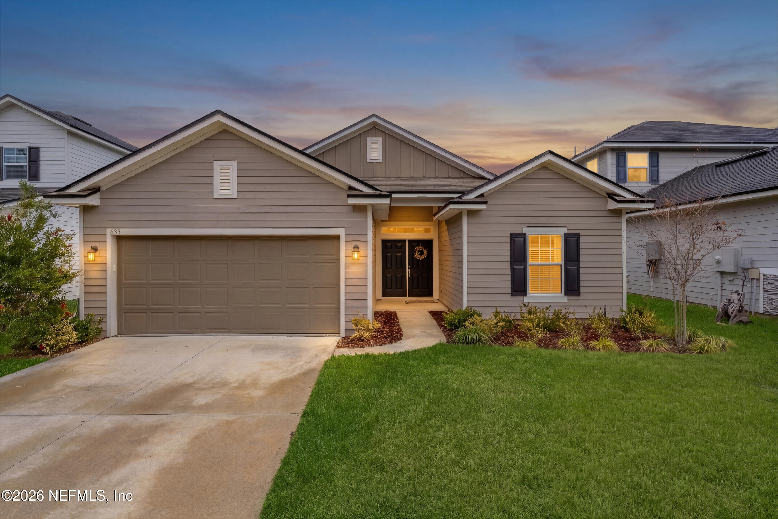 635 Sycamore Way Orange Park, FL 32073 - Photo 2 of 42 a front view of a house with a yard and garage