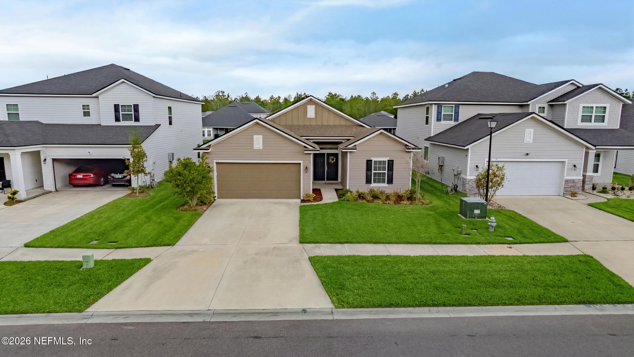 635 Sycamore Way Orange Park, FL 32073 - Photo 25 of 42 a front view of a house with a garden and plants