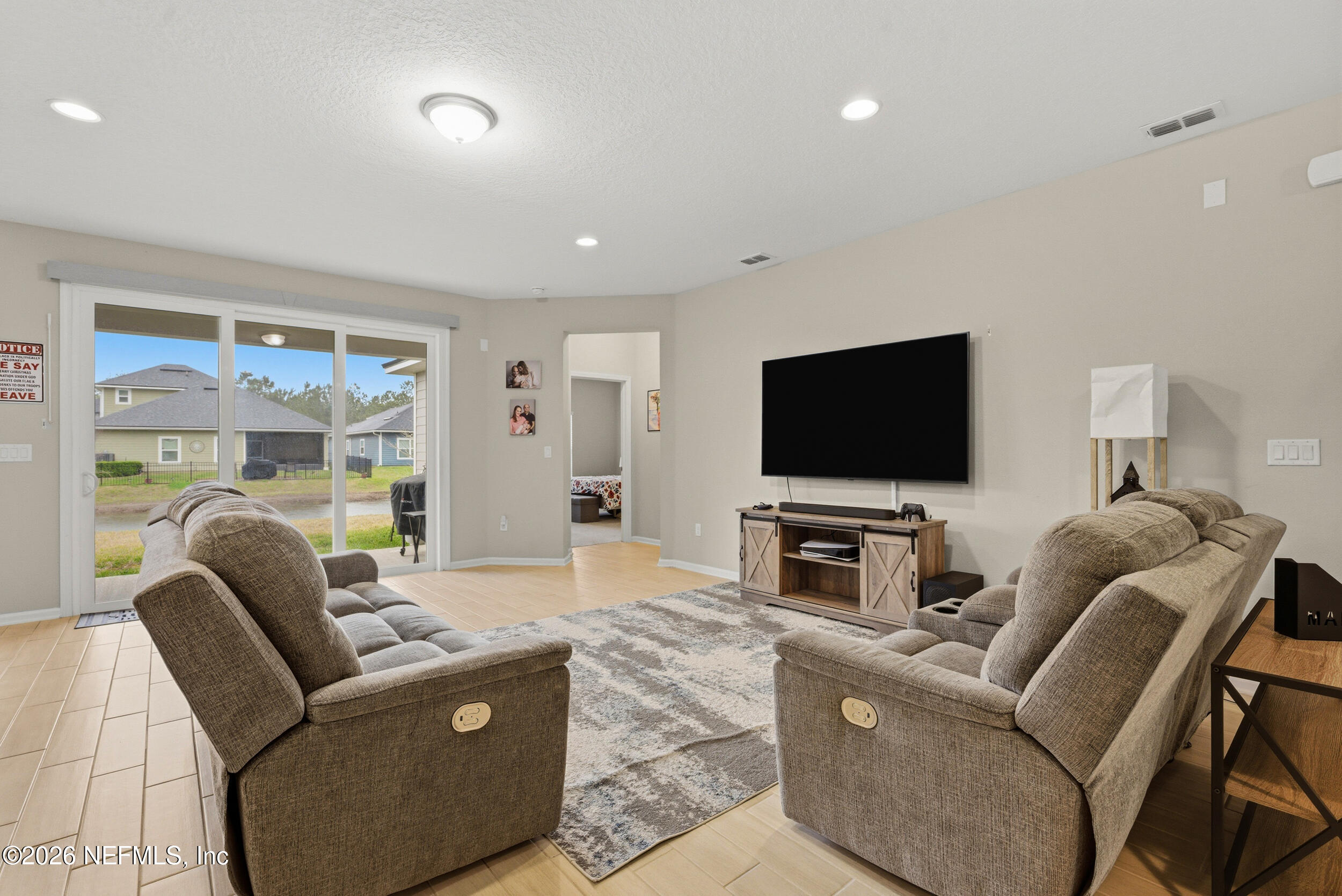 635 Sycamore Way Orange Park, FL 32073 - Photo 7 of 42 a living room with furniture and a flat screen tv
