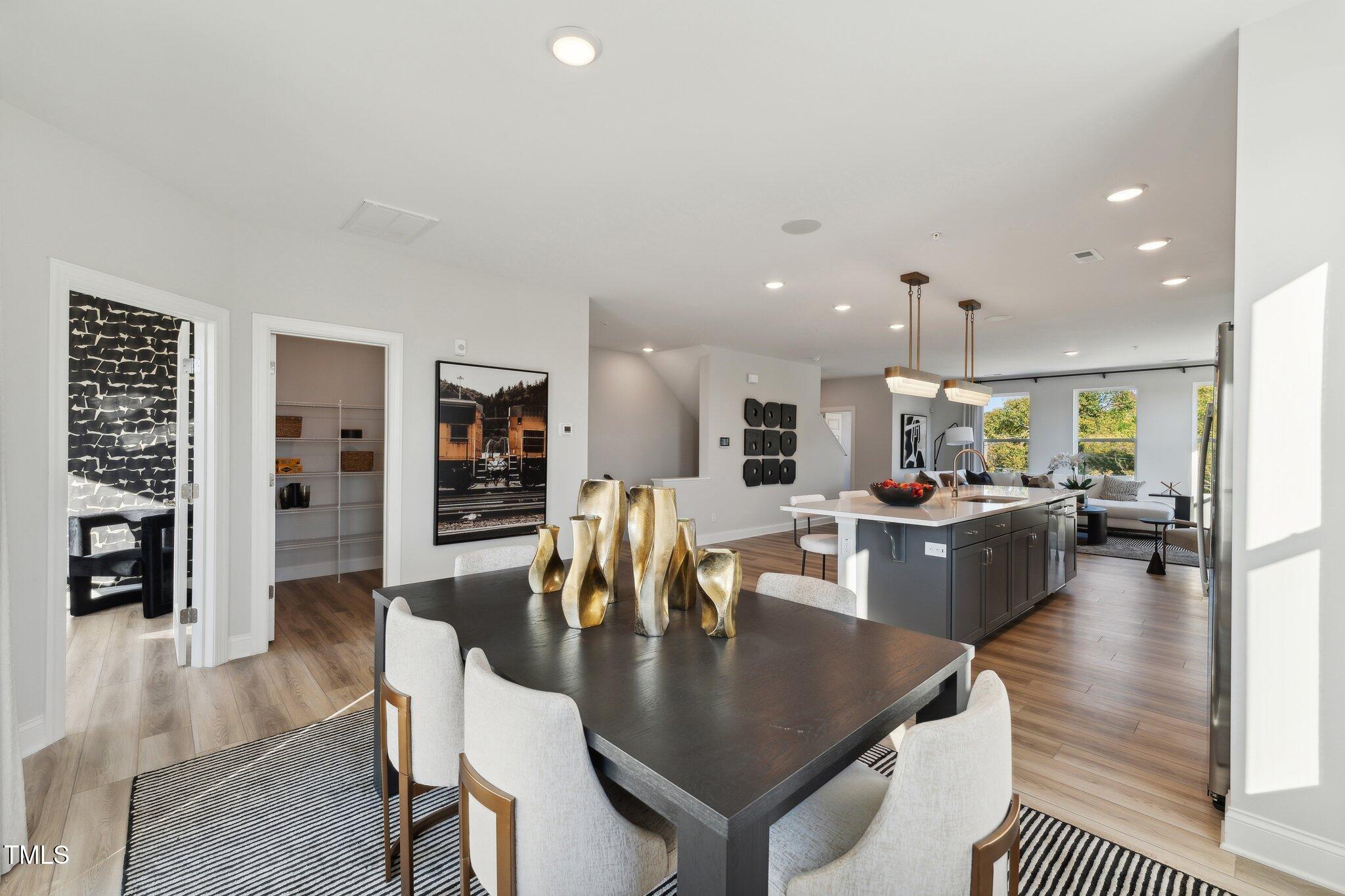 1236 South Person Street, Unit 201 Raleigh, NC 27601 - Photo 1 of 33 a dining room with wooden floor and kitchen view