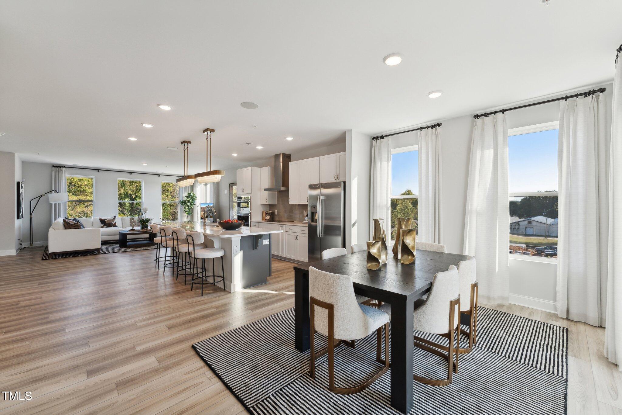 1236 South Person Street, Unit 201 Raleigh, NC 27601 - Photo 2 of 33 a view of a dining room with furniture and wooden floor