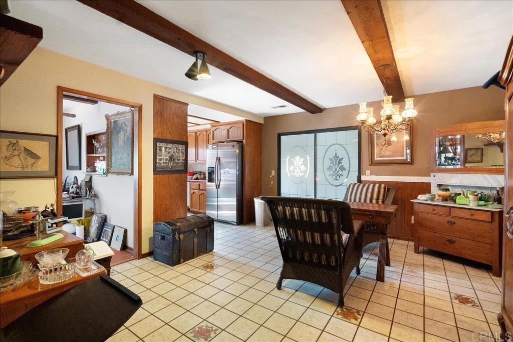 823 Rice Canyon Road Fallbrook, CA 92028 - Photo 19 of 31 a living room with furniture a chandelier and a dining table