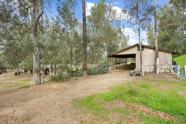 a view of a house with backyard and trees