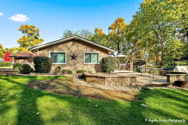 a view of a house with pool and sitting area