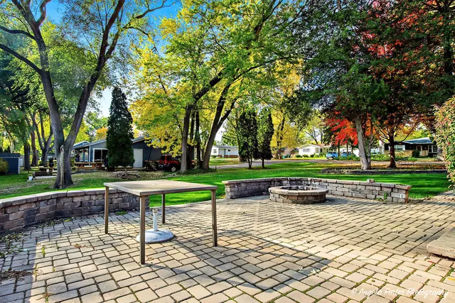 a view of a house with backyard and deck
