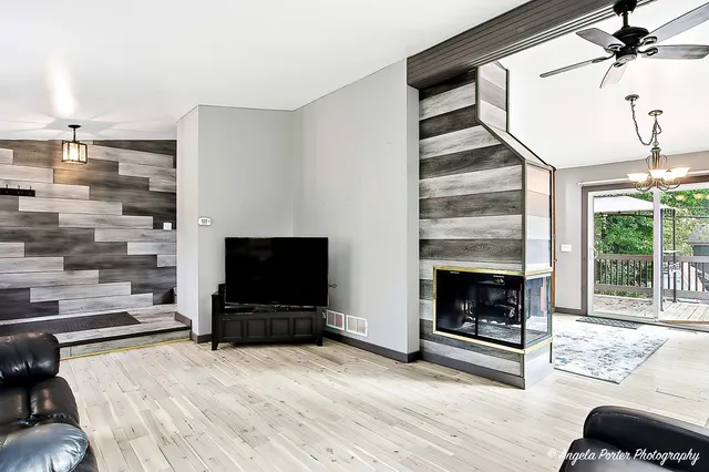 a living room with furniture and a fireplace or television