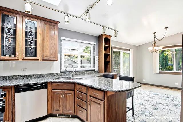 a kitchen with granite countertop sink and window