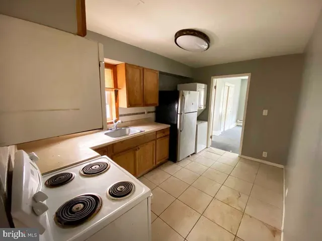 a kitchen with a refrigerator and a stove