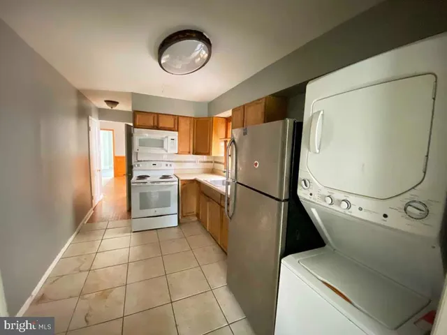 a kitchen with a refrigerator sink stove and cabinets