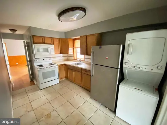 a kitchen with a refrigerator sink stove and cabinets