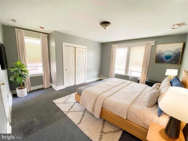 a bedroom with a bed and glass window