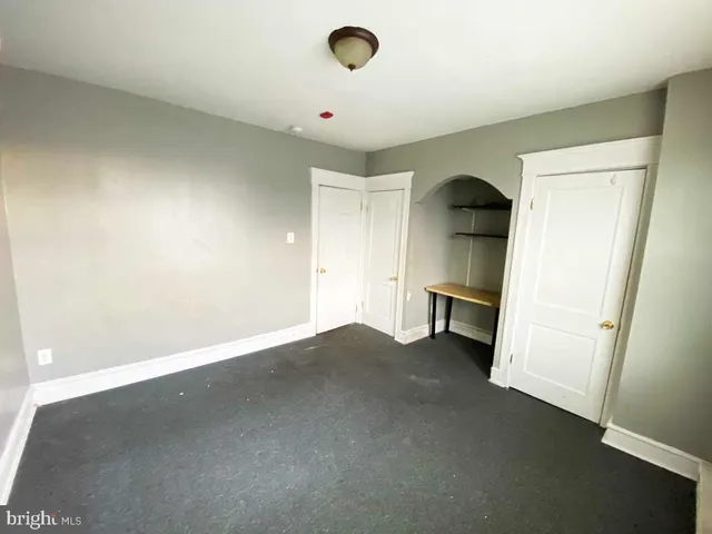 a view of an empty room and a window