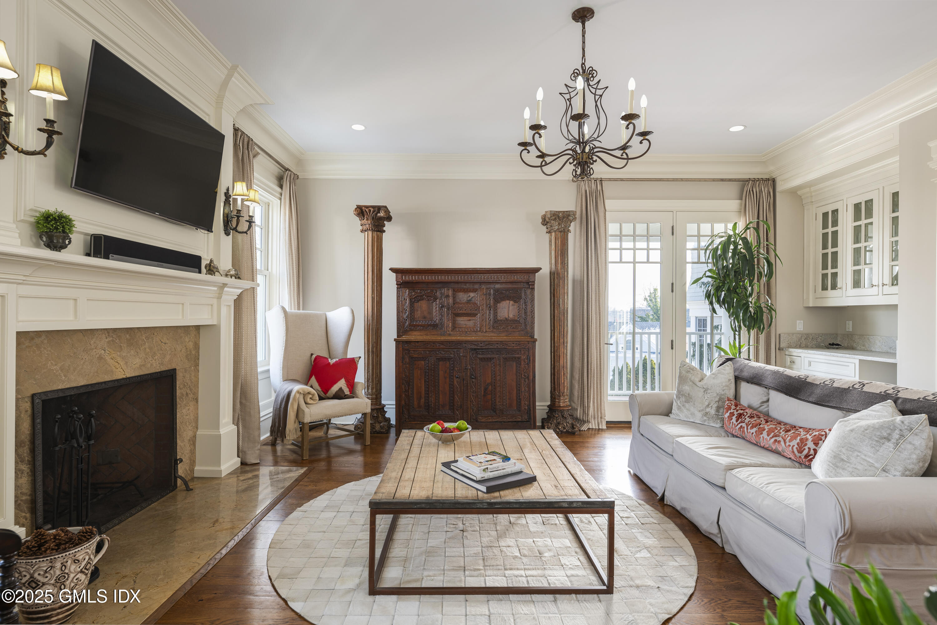 50 Sound View Drive, Unit 2N Greenwich, CT 06830 - Photo 11 of 37 a living room with furniture a fireplace and a flat screen tv