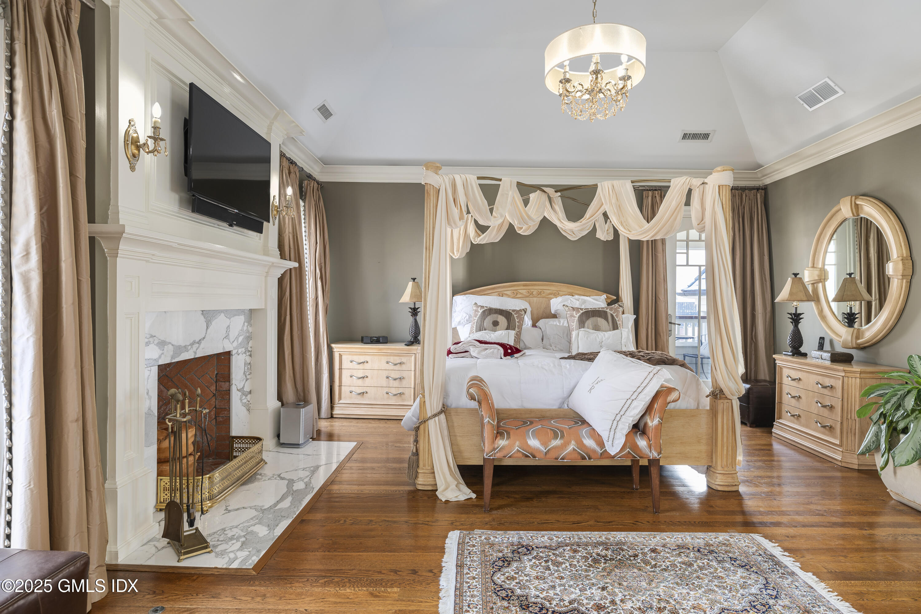 50 Sound View Drive, Unit 2N Greenwich, CT 06830 - Photo 14 of 37 a bedroom with furniture a fireplace and a flat screen tv