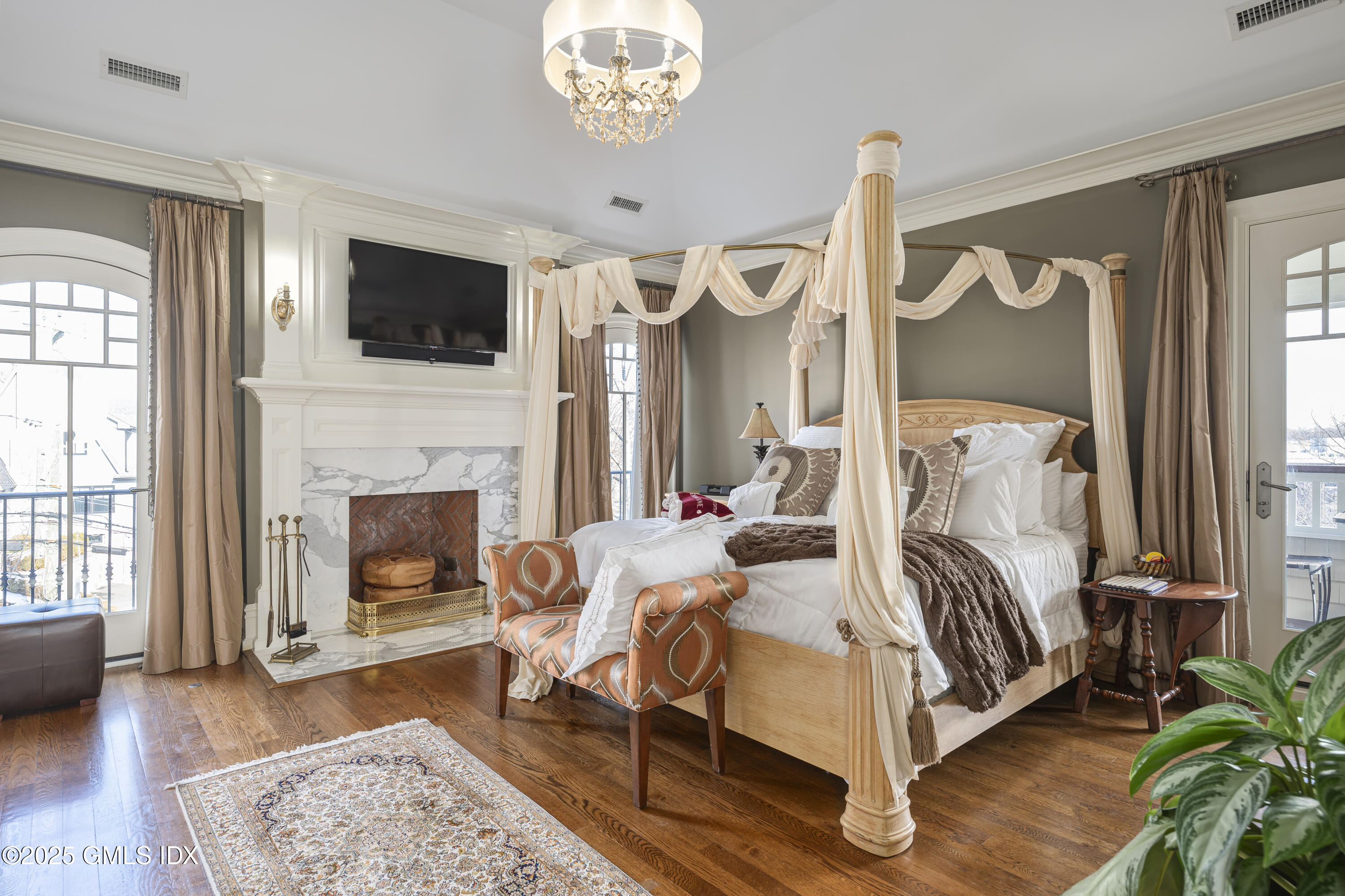 50 Sound View Drive, Unit 2N Greenwich, CT 06830 - Photo 15 of 37 a bedroom with a bed flat screen tv and a fireplace