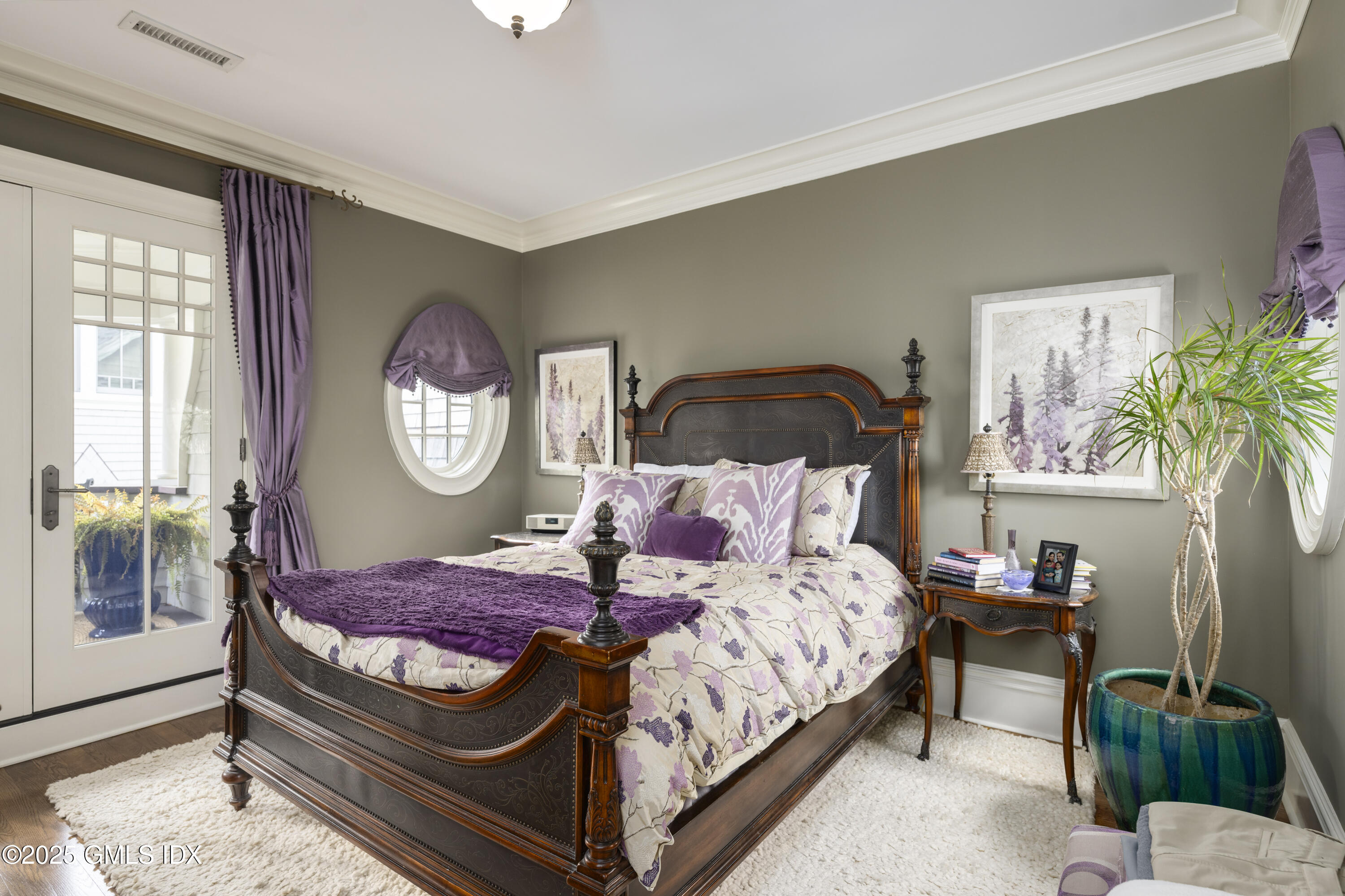 50 Sound View Drive, Unit 2N Greenwich, CT 06830 - Photo 18 of 37 a bedroom with a bed a mirror and a potted plant