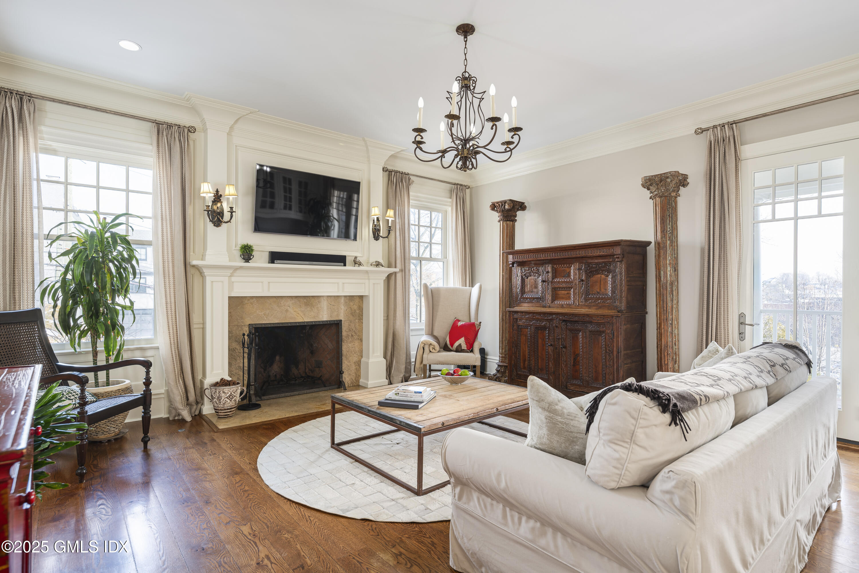 50 Sound View Drive, Unit 2N Greenwich, CT 06830 - Photo 9 of 37 a living room with furniture a fireplace and a flat screen tv
