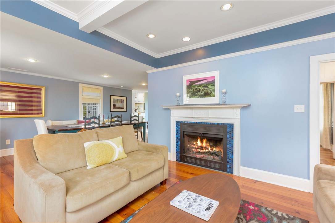 36 Post Road Warwick, RI 02888 - Photo 23 of 23 Living room with working fireplace and tray ceiling leads to open floor plan dining room.