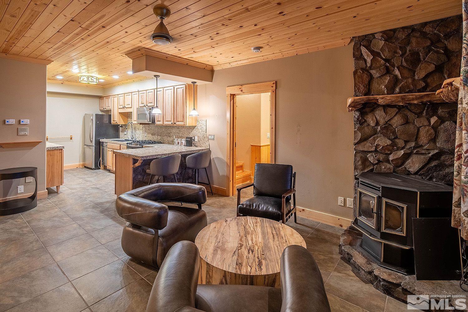 2710 Goldfield Road Reno, NV 89521 - Photo 27 of 39 a living room with furniture a fireplace and a flat screen tv