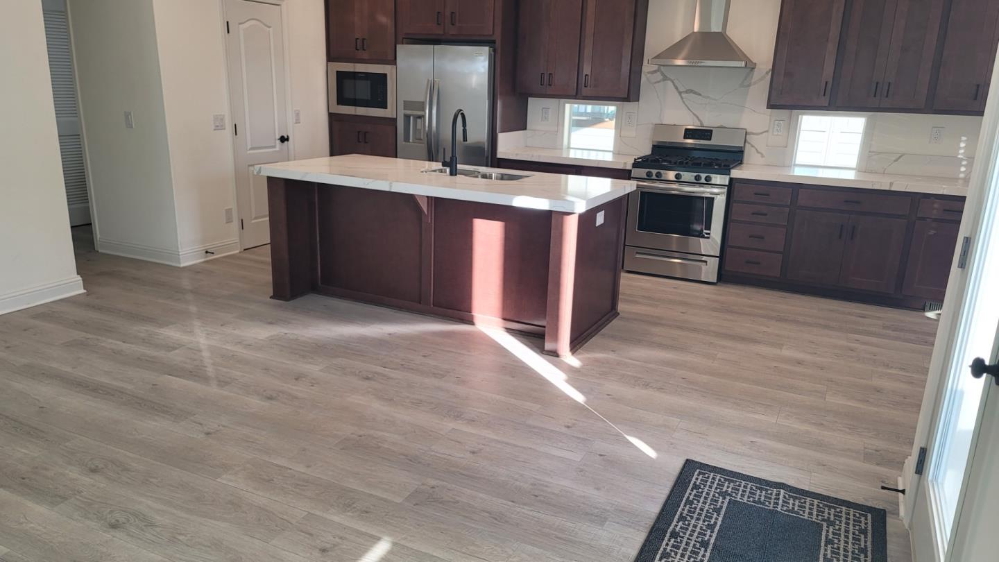 100 North Rodeo Gulch Road, Unit 108 Soquel, CA 95073 - Photo 2 of 16 a kitchen with stainless steel appliances granite countertop a stove a sink and a refrigerator