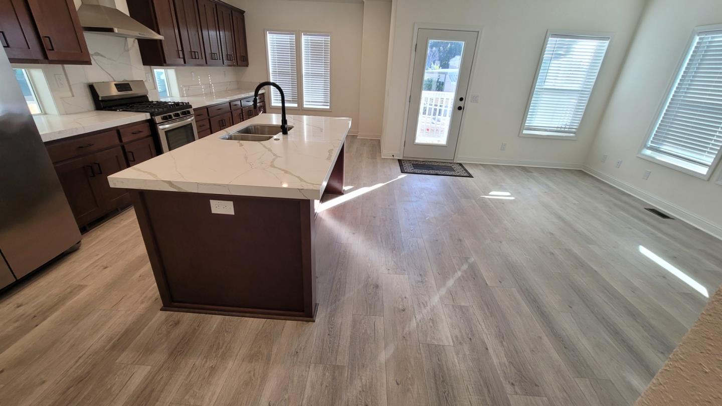 100 North Rodeo Gulch Road, Unit 108 Soquel, CA 95073 - Photo 3 of 16 a kitchen with a sink and a wooden floor