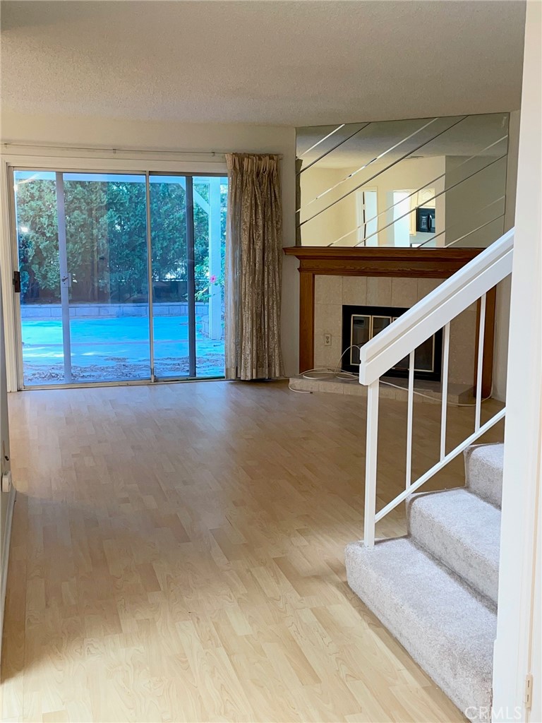 19500 Crystal Ridge Lane Porter Ranch, CA 91326 - Photo 12 of 33 a view of an empty room with wooden floor and windows