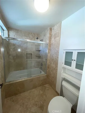 a bathroom with a shower and toilet