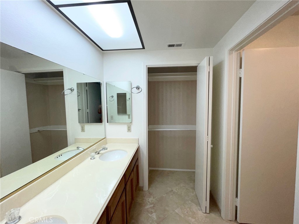 19500 Crystal Ridge Lane Porter Ranch, CA 91326 - Photo 23 of 33 a bathroom with a sink a mirror and a shower